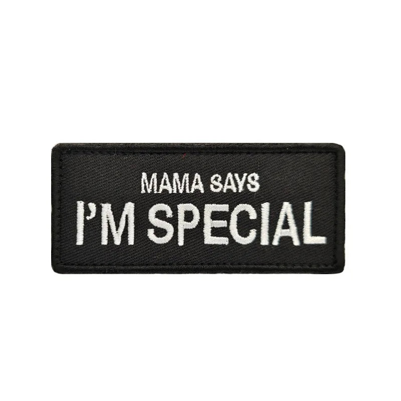 Black embroidered pet harness tag that says Mama Says I'm Special