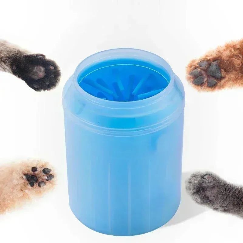 A blue portable paw washer cup filled with water and featuring soft silicone bristles, surrounded by pet paws.