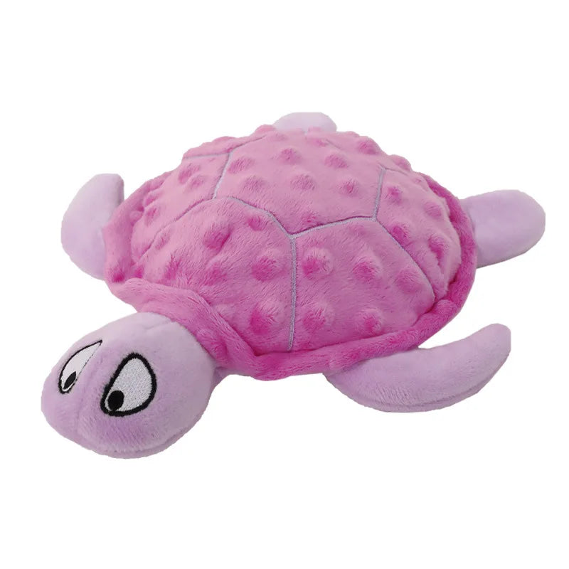 A pink and purple plush toy shaped like a turtle for puppies