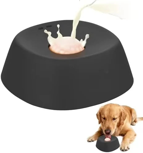 A dark gray ergonomic slow feeder dog bowl with a white food being dispensed onto the surface.
