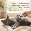A hand is using a stainless steel pet detangling comb on a gray cat lying on a cream-colored mat.