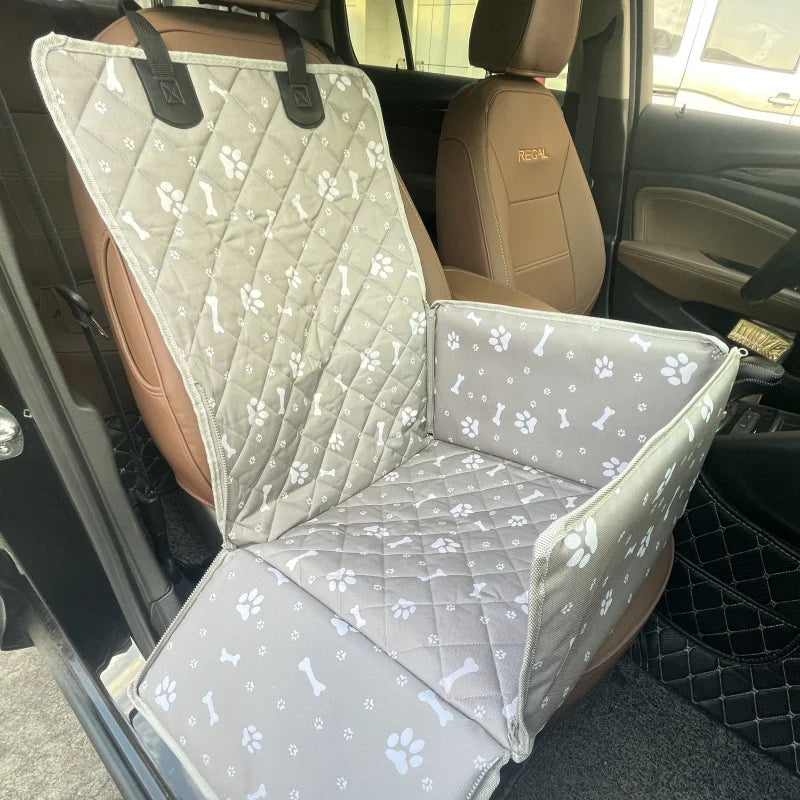A beige waterproof dog car seat hammock installed in the back seat of a vehicle.