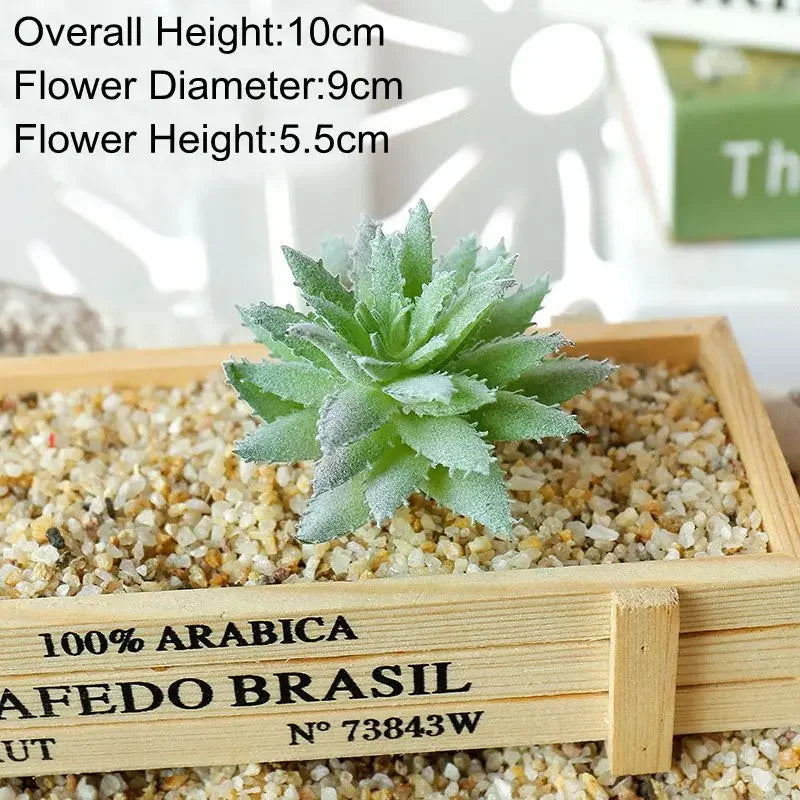 A green flocked artificial succulent plant in a wooden tray with light gravel.