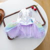 A white and purple tulle birthday suit for a small puppy, featuring a bodice and layered skirt.