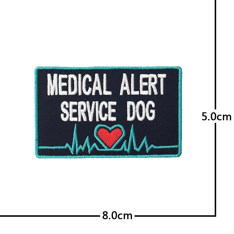 A dark blue embroidered patch for a medical alert service dog featuring text and a red heart symbol.