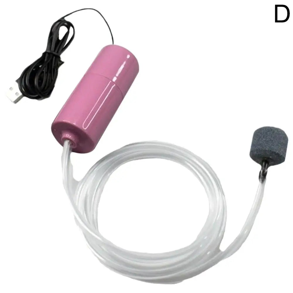 Pompe à air pour aquarium mini rose avec tuyau transparent et pierre d'air.