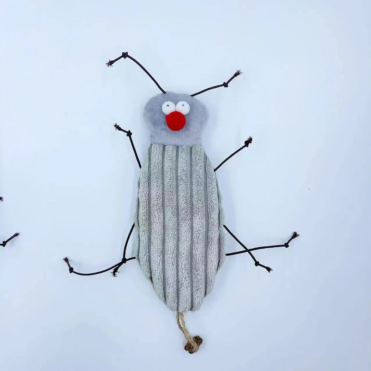 A plush toy resembling a cockroach with large eyes and antennae, featuring gray body and red mouth.