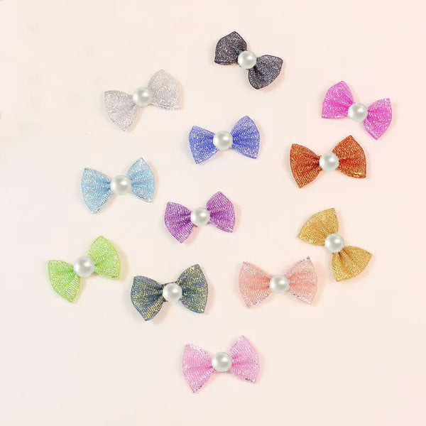 A collection of various colored and glittery puppy dog bow knots for hair grooming.