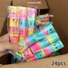 A hand holds a package of colorful spring coil toys featuring smiling faces in pink, yellow, and blue hues.