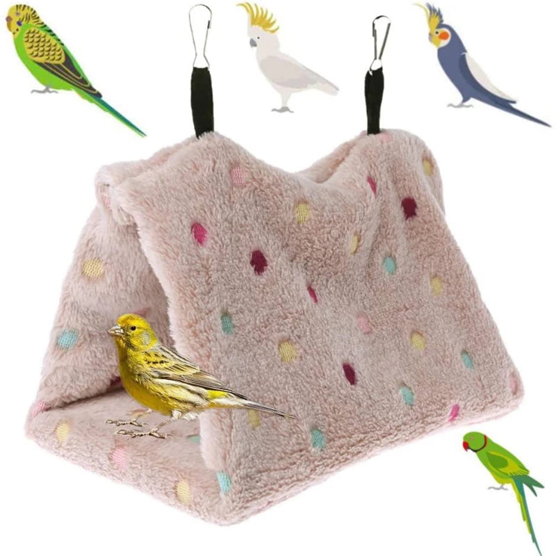 A plush parrot hammock bed featuring a soft pink fabric and various colorful bird figurines.