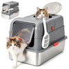A stainless steel enclosed litter box for cats with a tabby kitten looking out of the box.