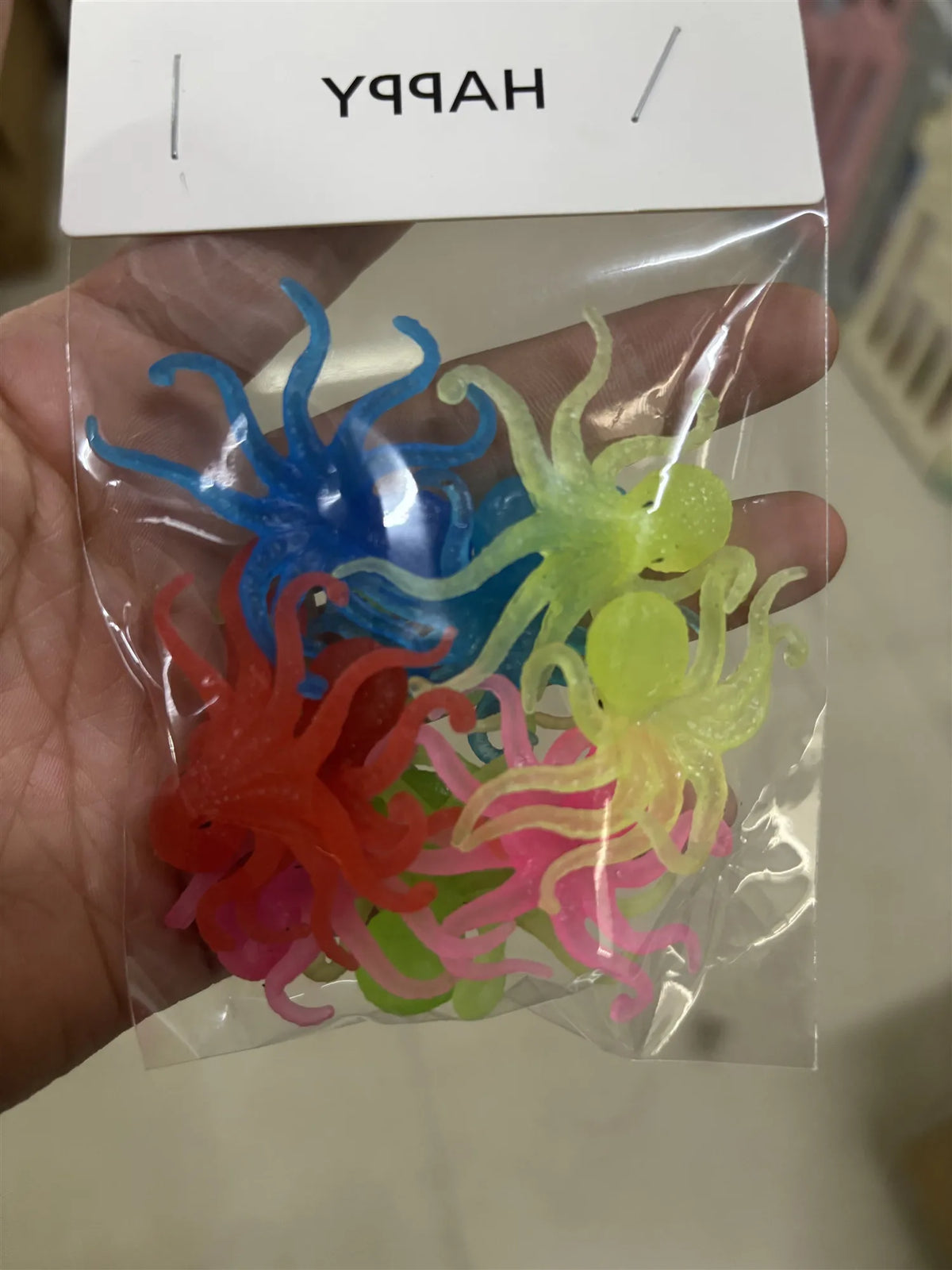 A clear plastic bag contains a set of ten colorful soft rubber goldfish bath toys.