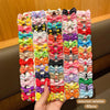Assorted varieties of colorful fabric hair clips in various patterns and colors