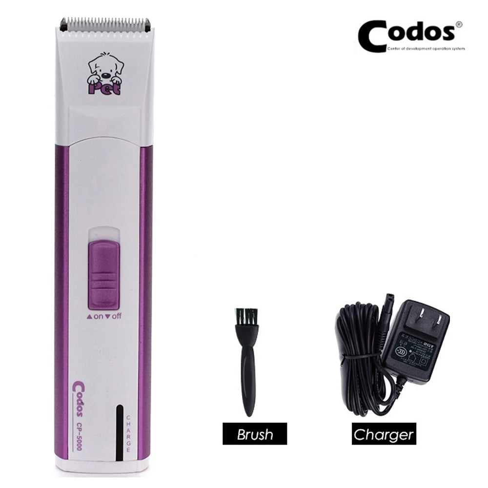 A white electric pet grooming clipper with a purple brush and charger cable.