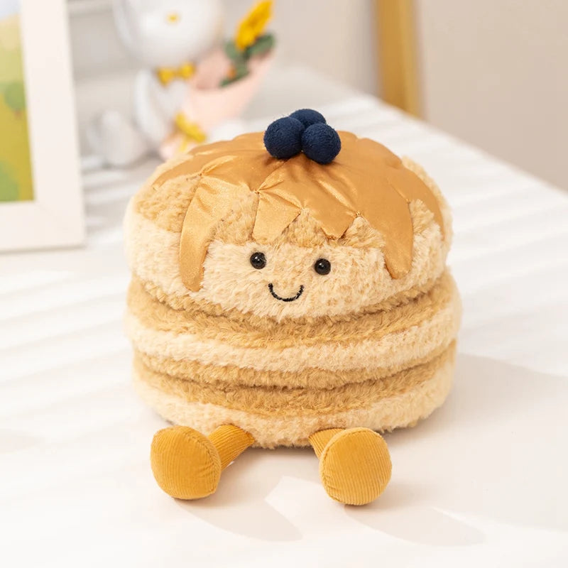 A fluffy, round plush toy resembling a dessert with golden-brown hair and yellow feet.