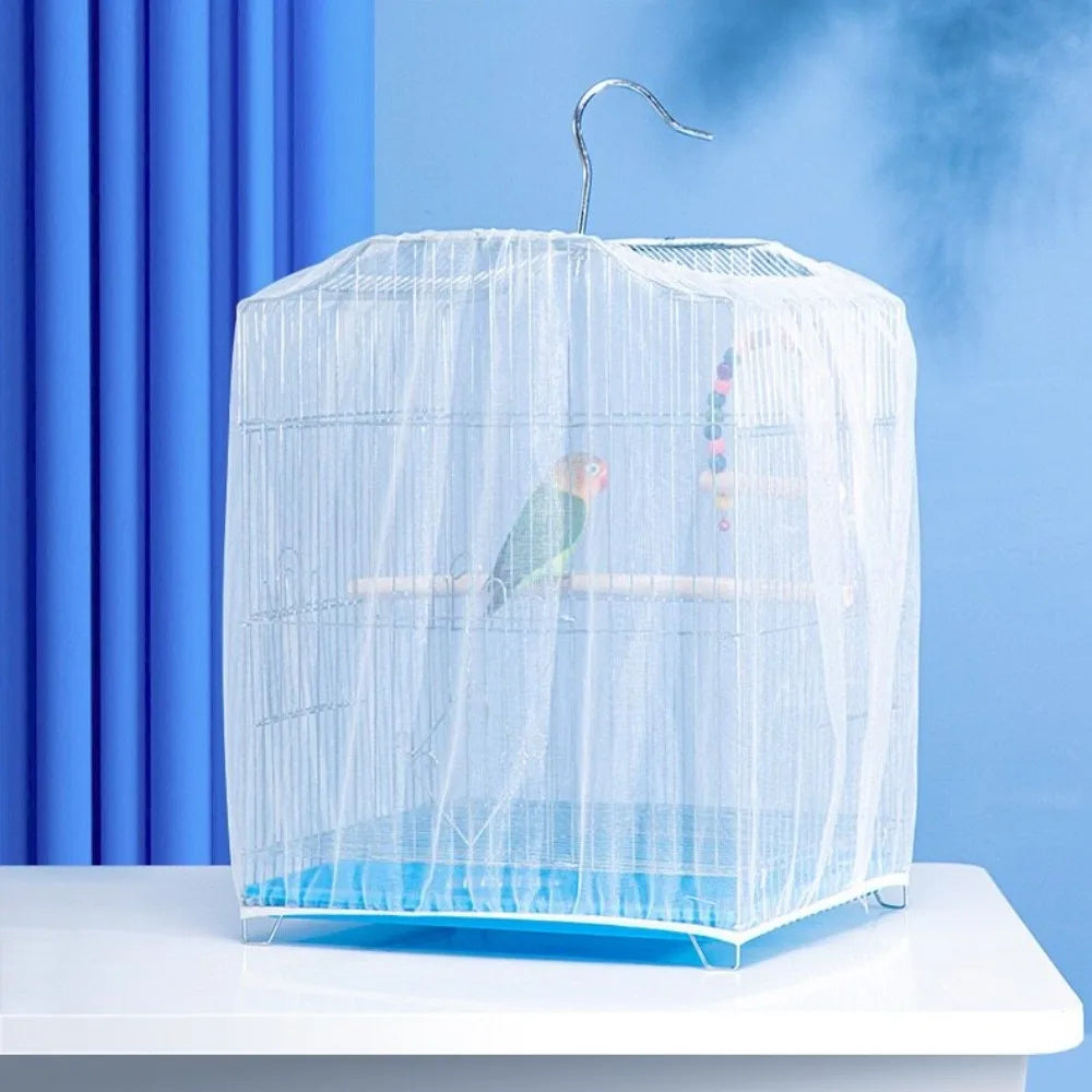 A clear mesh bird cage with a dome top and blue base sits on a white surface.