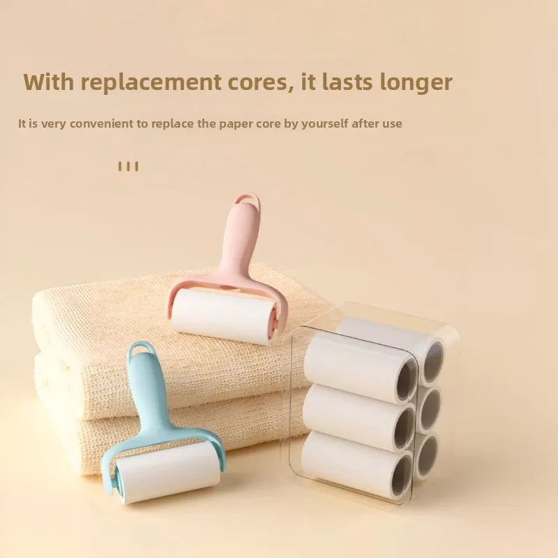 A pink mini lint roller with a replaceable adhesive paper core is shown next to a stack of towels.