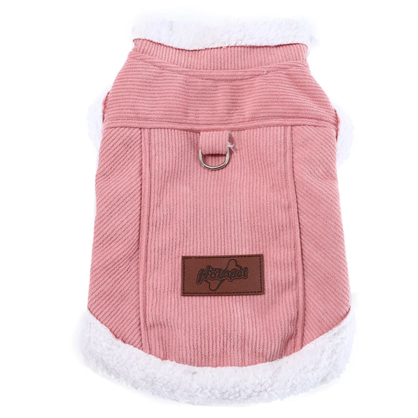 A pink cozy fleece dog vest with a white faux fur trim and a metal D-ring for small to medium breeds.