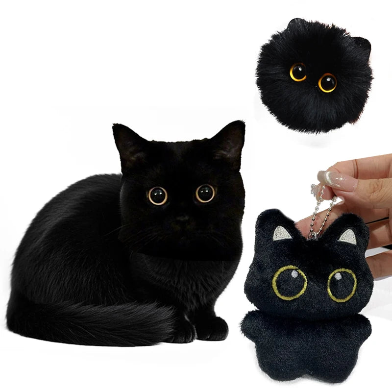 A black cat plush pendant with large yellow eyes and white accents, shown next to a real black cat.