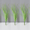 Five vertical stalks of green onion grass used as garden decoration