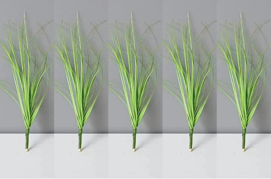 Five vertical stalks of green onion grass used as garden decoration