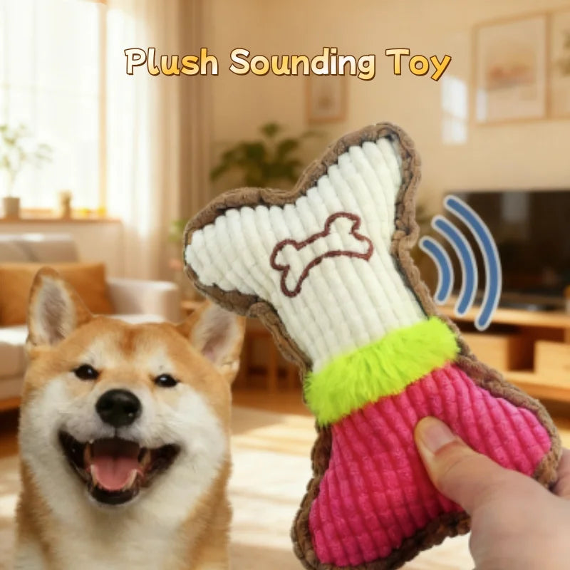 A hand is holding a plush squeaky bone dog toy shaped like a bone, next to a happy dog.