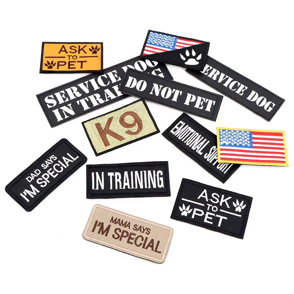 A set of personalized tactical patches featuring text like I'm special and in training for dogs