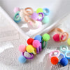 A collection of colorful elastic pet hair bows with rubber bands in various shades of pink, yellow, blue, and green.