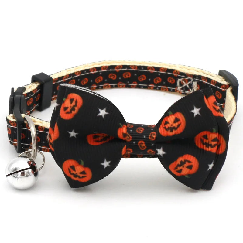 Adjustable Halloween pet collar featuring a black bow tie with orange pumpkin designs and a silver bell.