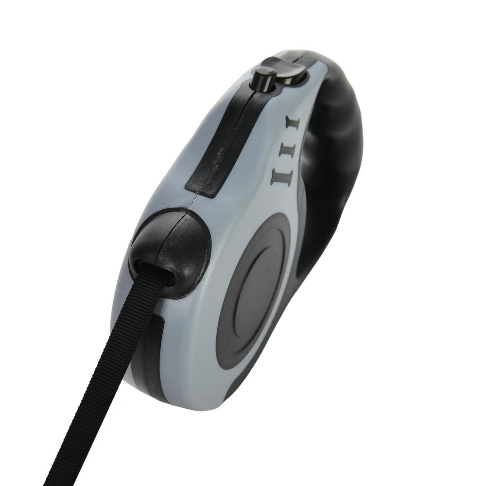 A gray retractable dog leash with a black strap and a handle is shown from a top-down angle.