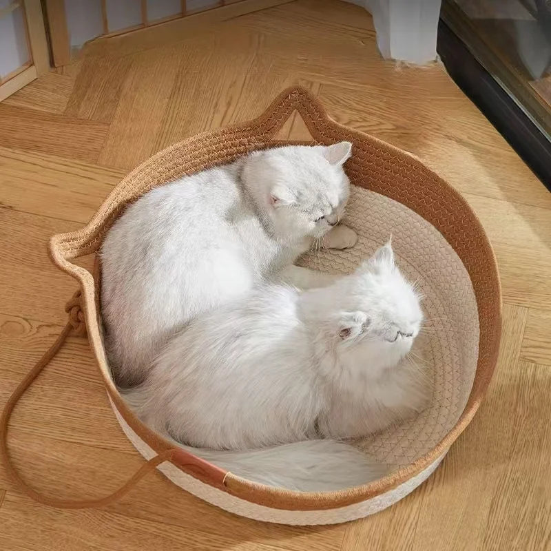 A handwoven rattan cat bed with a cotton rope edge, holding two fluffy white cats.
