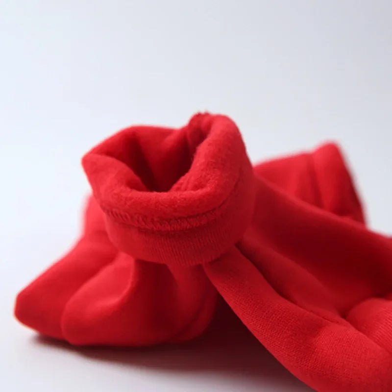 A bright red cozy fleece pet hoodie for dogs shown in a close-up view.