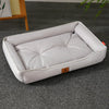 A white, tufted pet sofa bed for dogs and cats resting on a gray carpet.