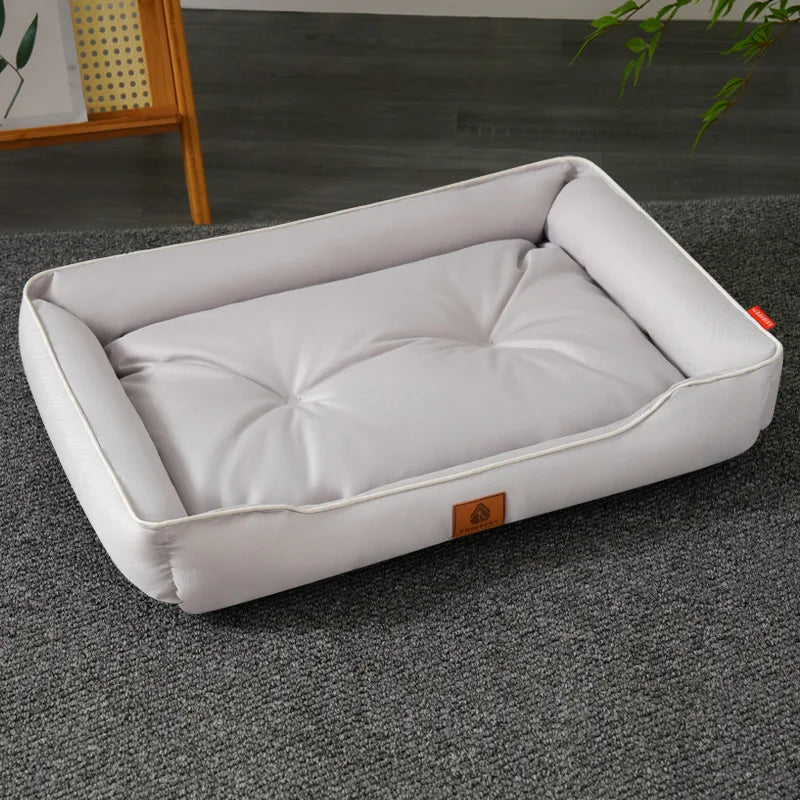 A white, tufted pet sofa bed for dogs and cats resting on a gray carpet.