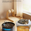 Automatic pet water fountain with a dark base and clear water flowing, placed near a cat.