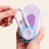 A hand holds a purple 3-in-1 self-cleaning cat grooming brush with soft massage bristles.
