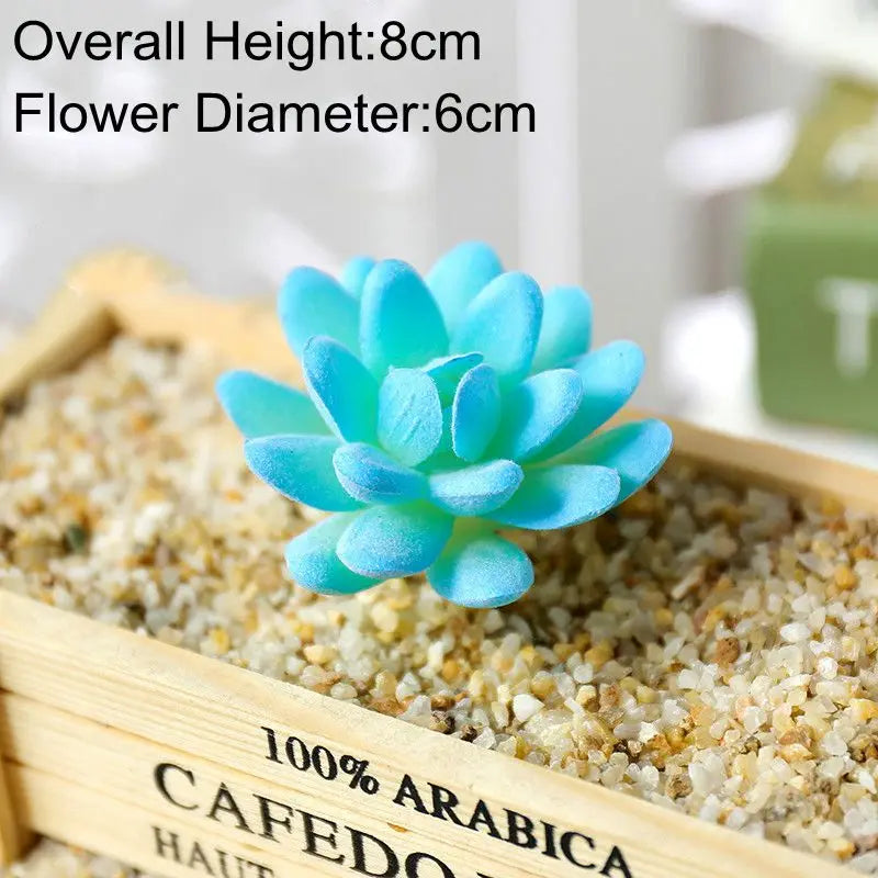 Blue artificial succulent plant in a wooden box filled with sand for desk decor