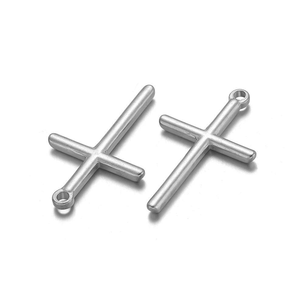 A pair of silver vintage cross charms used for DIY jewelry making.