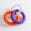 Three colorful TPR pull rings, including clear speckled, orange, and purple, for dog chew toys.