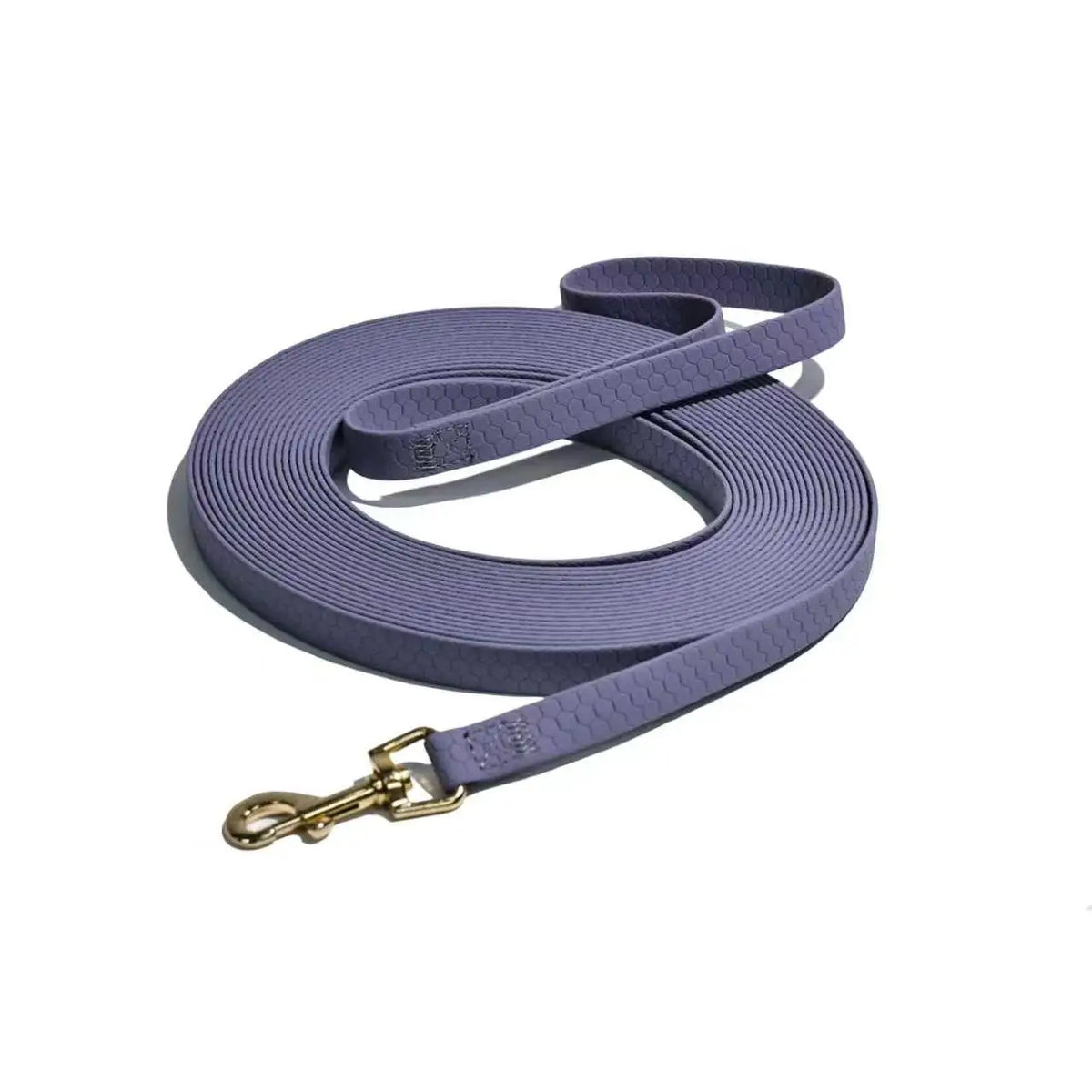 A purple durable waterproof dog leash with a rustproof metal hook coiled and laid out.