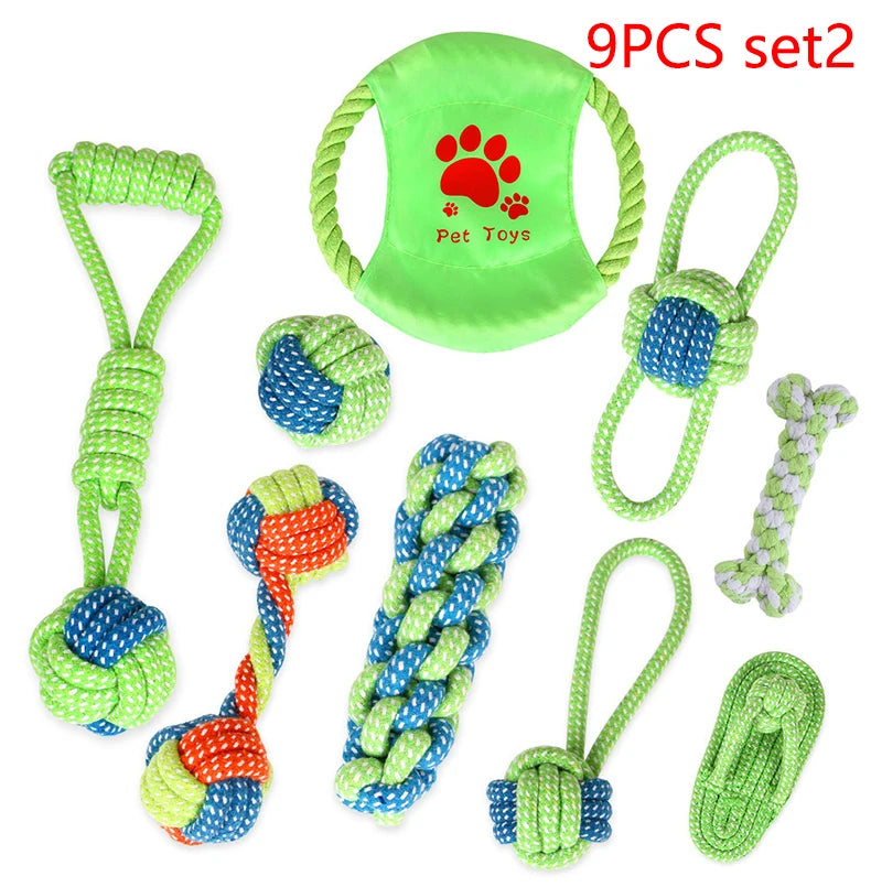A set of nine green and blue cotton rope dog toys including a green pet toy, various braided ropes, and a small green toy.