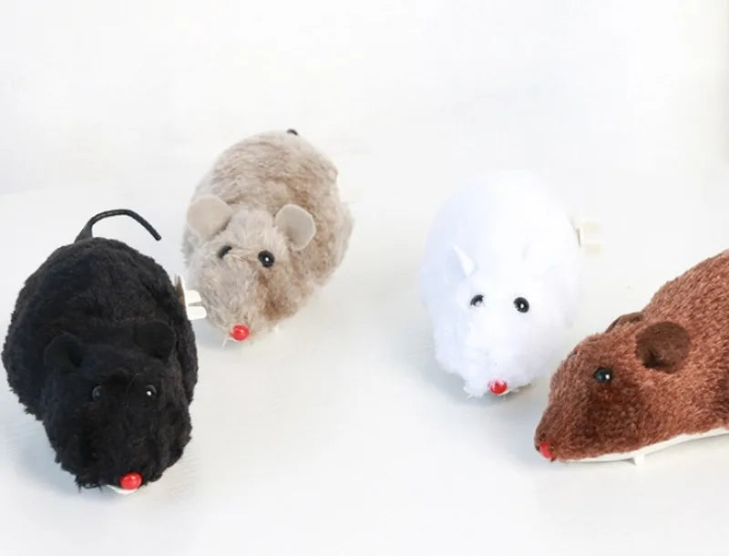 A collection of four plush mouse toys in black, gray, white, and brown colors displayed on a white surface.