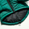 A dark green quilted winter coat with a black zipper and lining is shown flat.