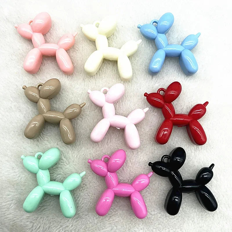 A collection of colorful acrylic balloon dog charms in various pastel and bright colors.