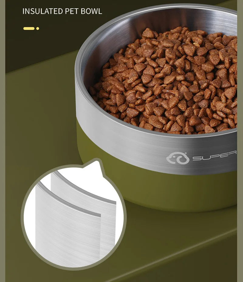 A stainless steel insulated pet bowl filled with dry kibble, shown on a green surface.