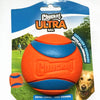 Orange and blue Chuckit Ultra ball for dogs shown against a green outdoor background.