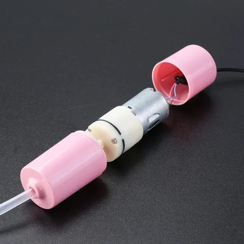 A pink and silver USB silent air pump for aquarium oxygenation with a clear tube.