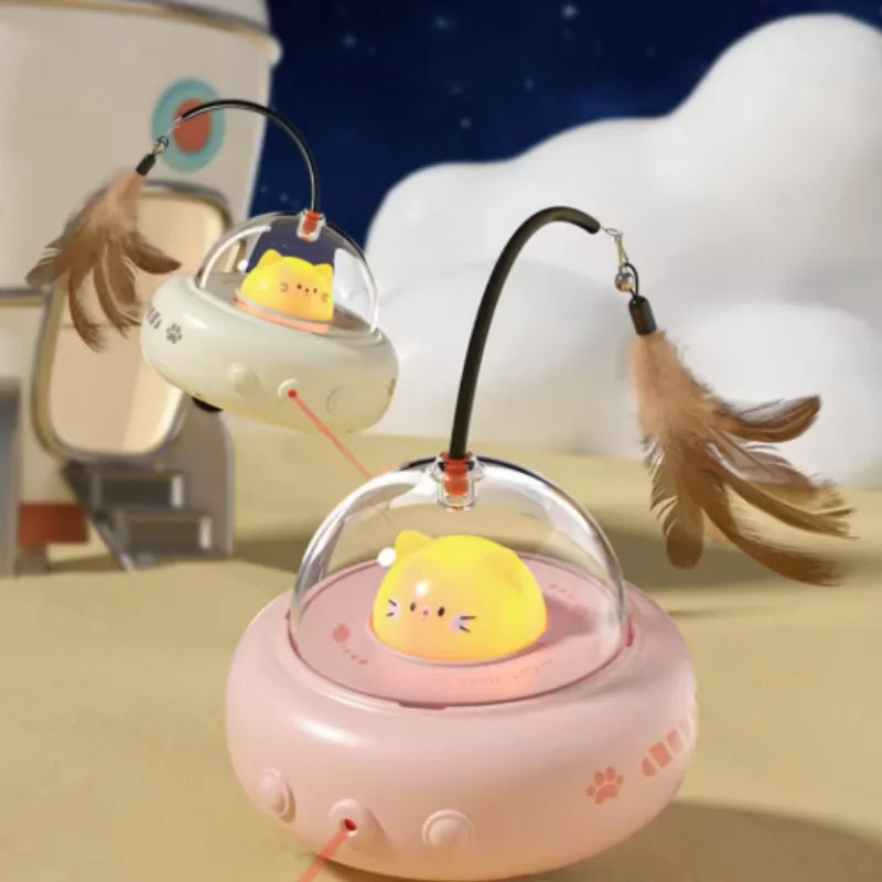 A pink interactive rotating feather cat toy with a yellow cat figure is shown against a white cloudy background.