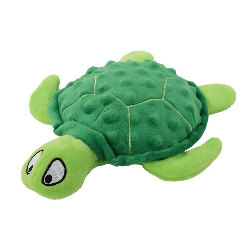 A plush toy of a green turtle with a head and limbs, designed as an interactive squeak dog toy for puppies.
