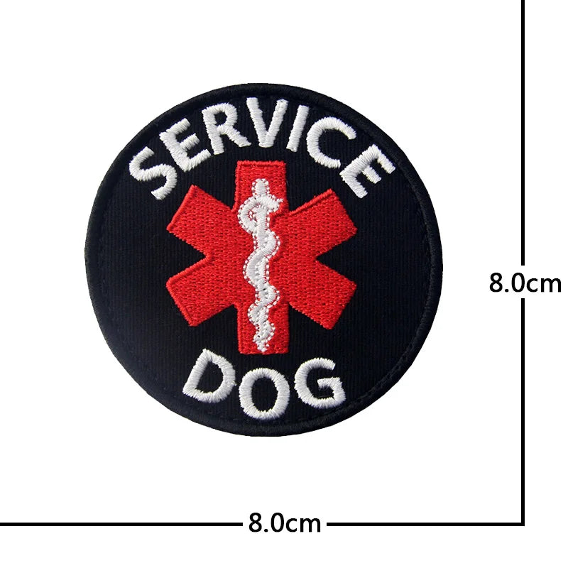 Black embroidered patch with red cross and white bone design featuring the words SERVICE and DOG